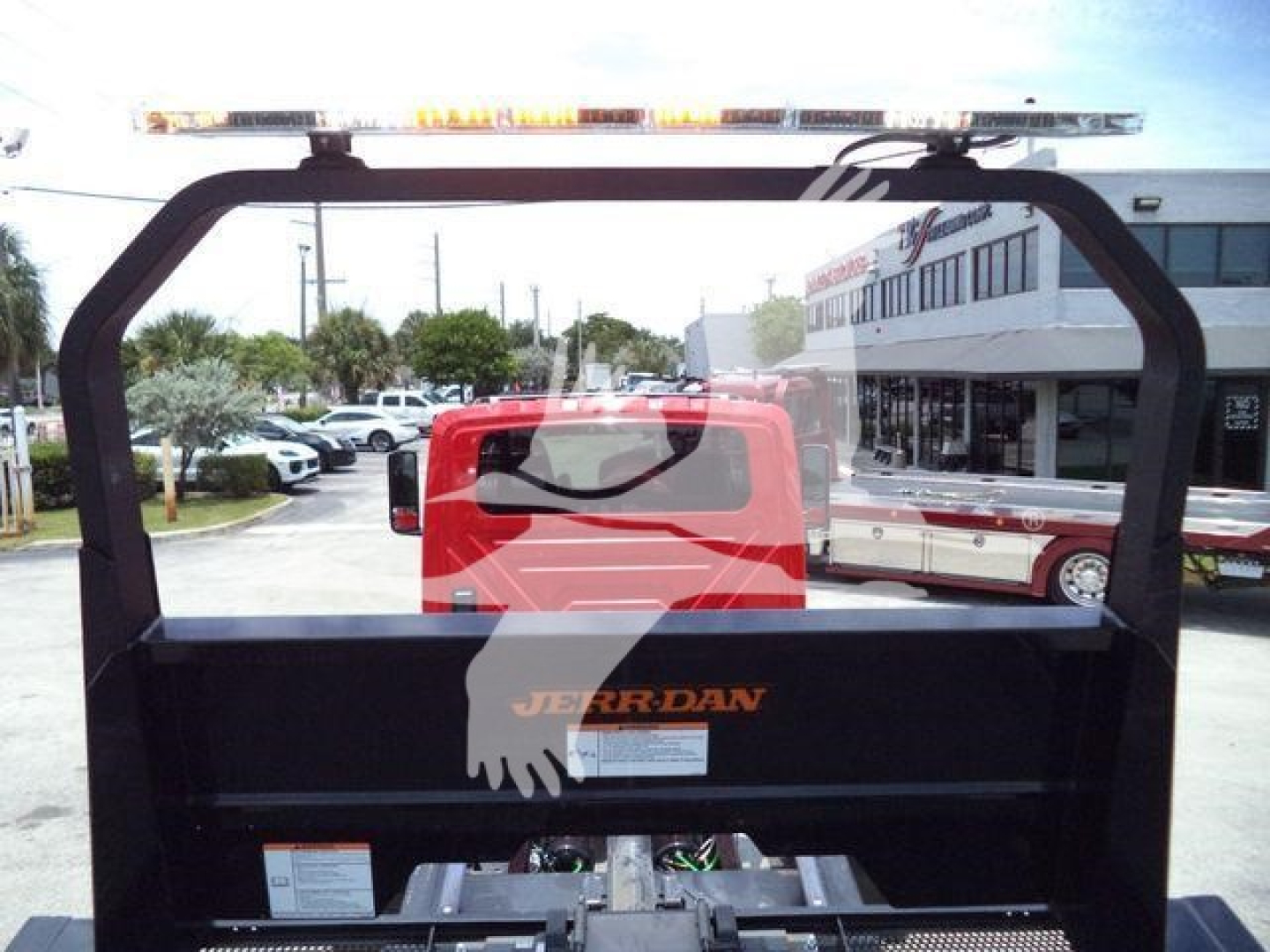 Back of a Jerr-Dan rollback hoist on a 2027 International MV truck, with reflective amber light bar on top and the JERR-DAN logo visible on the bed.