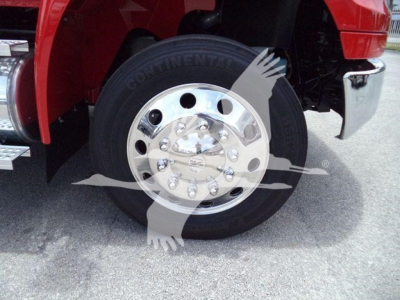 Truck wheel and tire shown with Continental tire brand on black rubber, polished chrome hubcap, red truck fender, chrome bumper; part of rollback truck undercarriage visible.