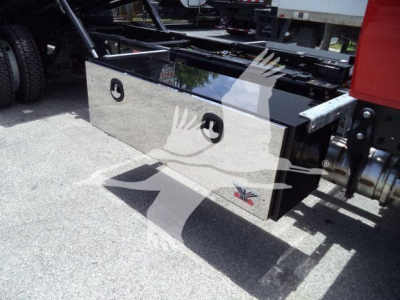 Boxed stainless steel toolbox mounted on side of a heavy truck chassis, with reflective Union Jack badge and mounting brackets visible.