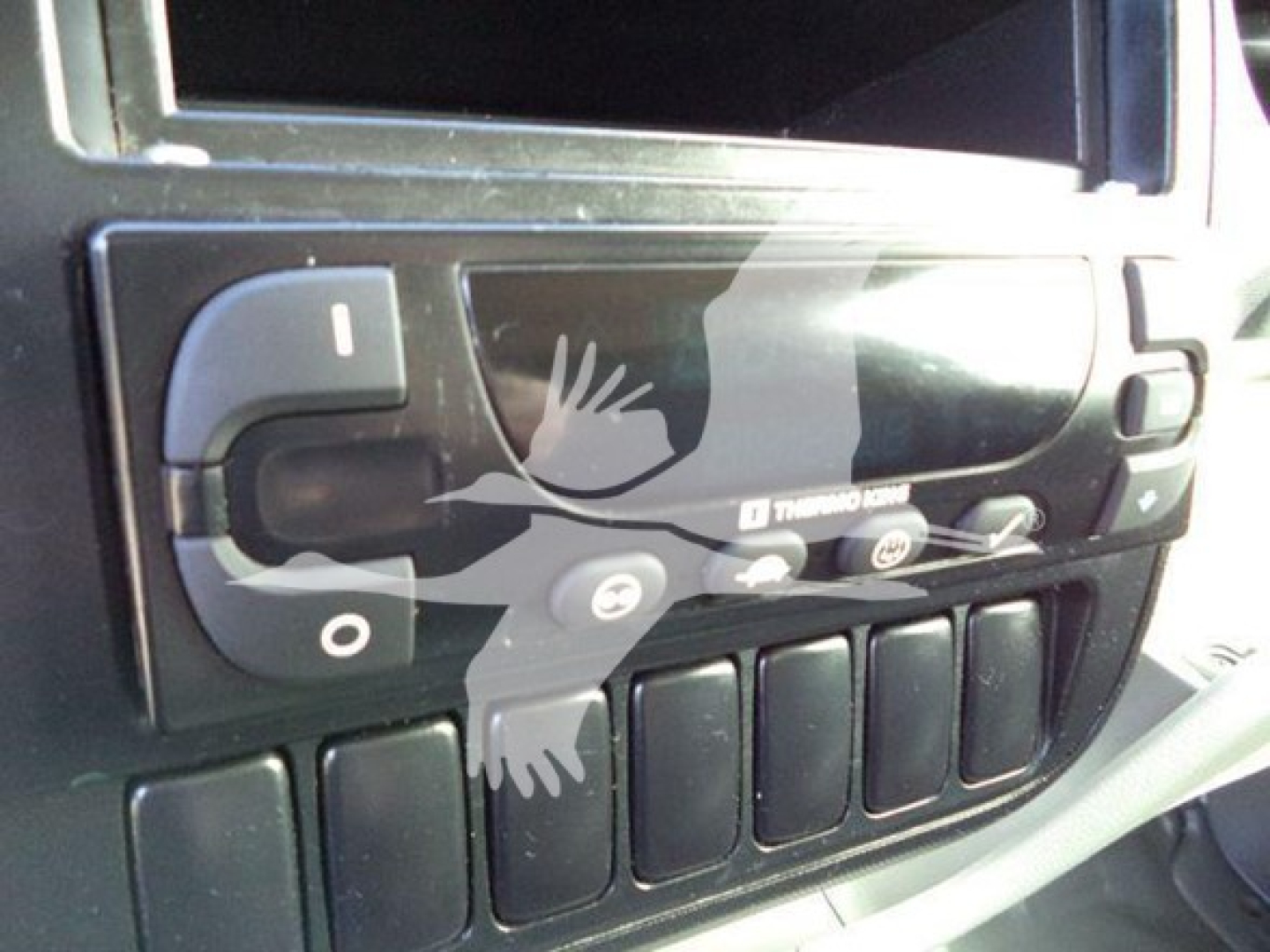 Truck cab interior showing glove box controls and dashboard switches in a 2020 Hino 195 refrigerated truck.