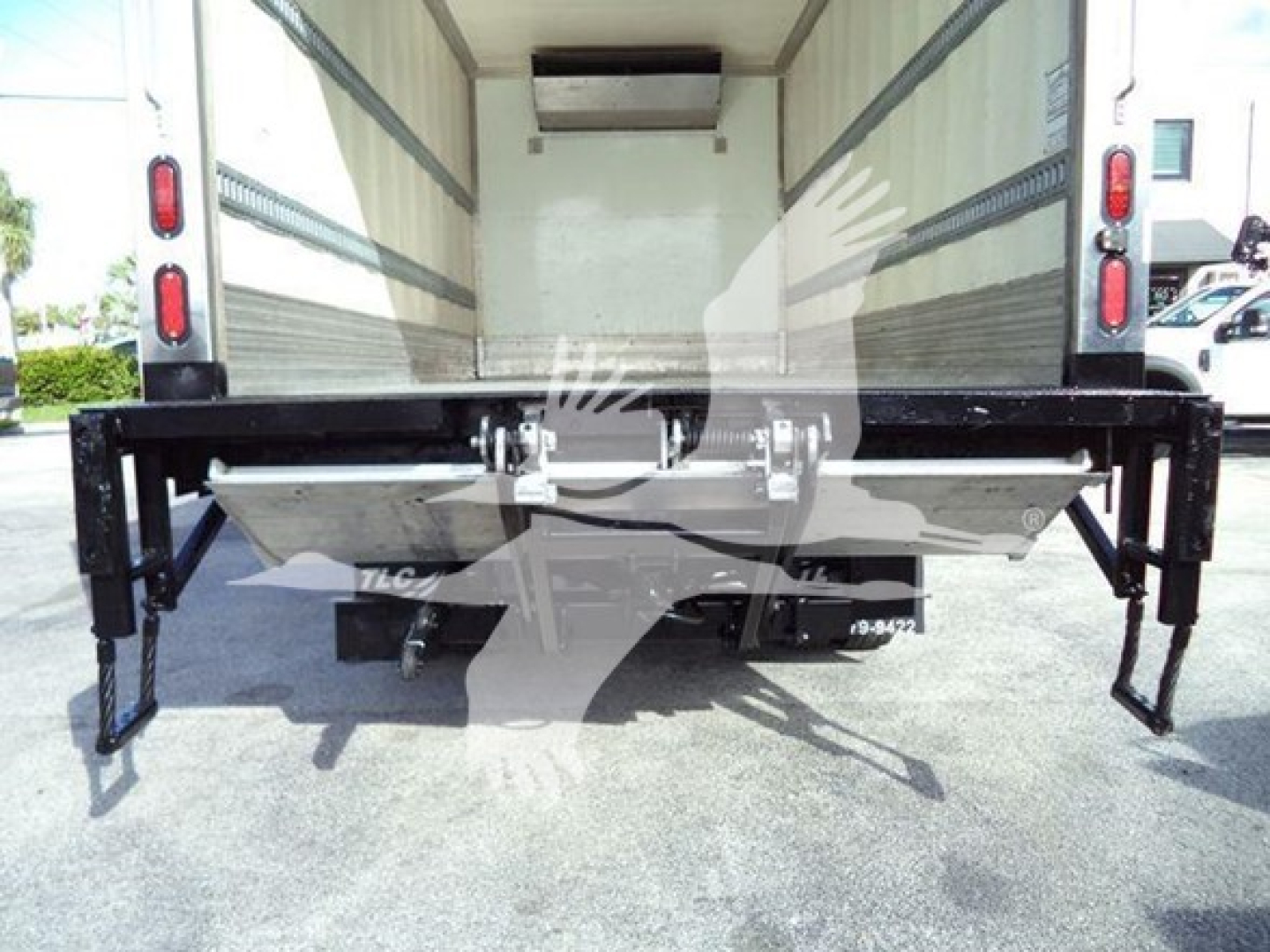 Truck rear view showing liftgate and undercarriage components of a 2020 Hino 195 refrigerated truck.