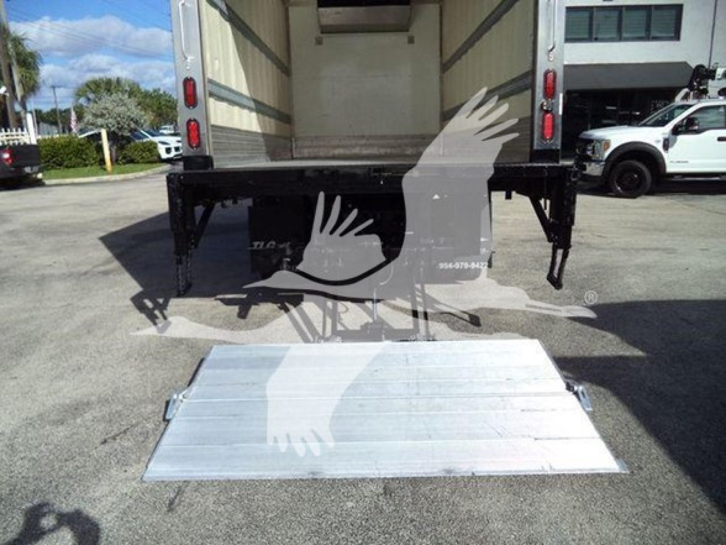 Rear view of a 2020 Hino 195 refrigerated truck with a deployed aluminum fold-out liftgate