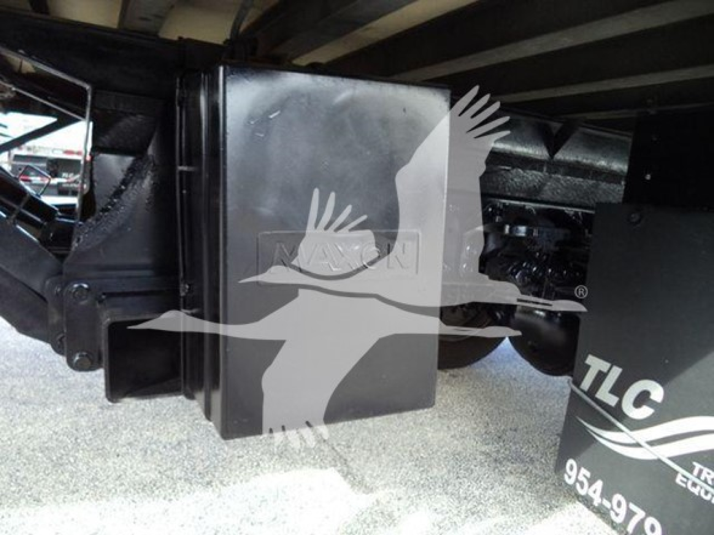 Truck hitch area of a 2020 Hino 195 refrigerated truck showing a black metal hitch mount and rear undercarriage components.