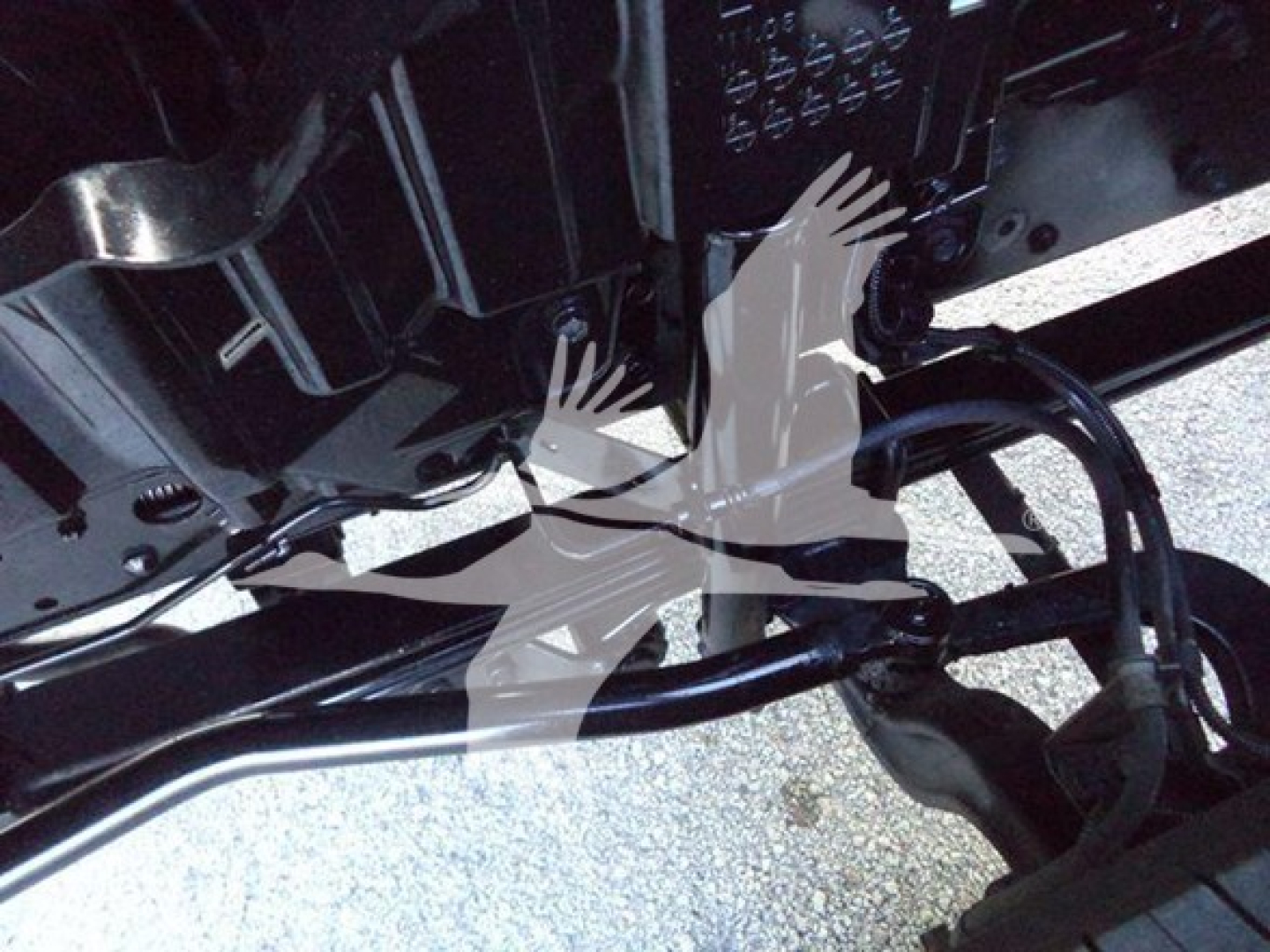 Underneath view of a 2020 Hino 195 refrigeration truck chassis showing exposed hoses, brackets, and frame after maintenance.