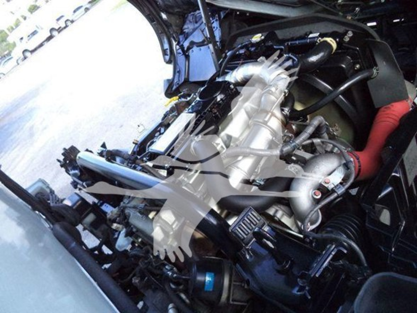 Hino 195 engine bay view showing engine components and hoses