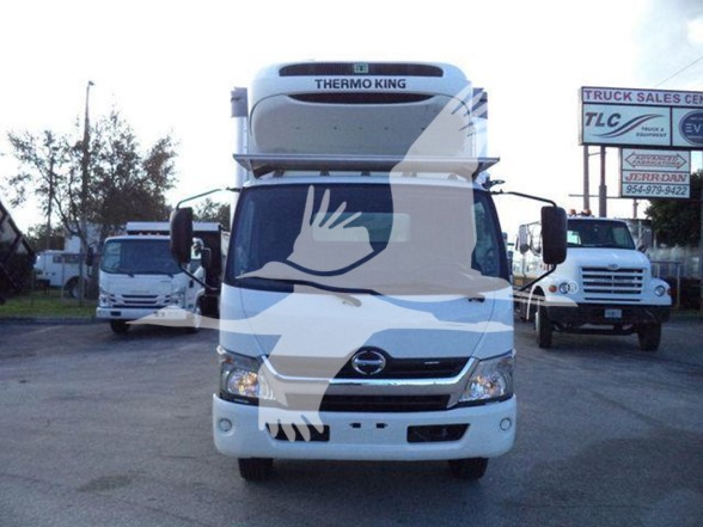 Front view of a white 2020 Hino 195 refrigerated truck with Thermo King unit on top, street in background, stock number T08316.
