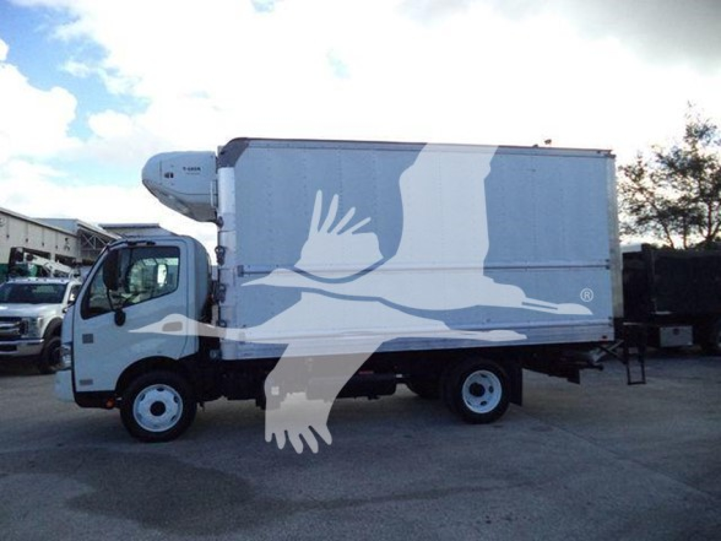Hino 195 refrigerated truck side view showing refrigeration unit on cab and cargo box.