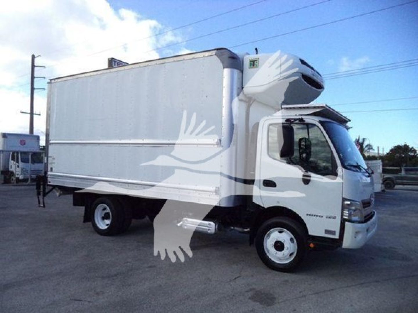 2020 Hino 195 refrigerated truck showing side view and cab with refrigeration unit mounted on top front. Visible text includes Hino branding on the cab and refrigerated box outline.