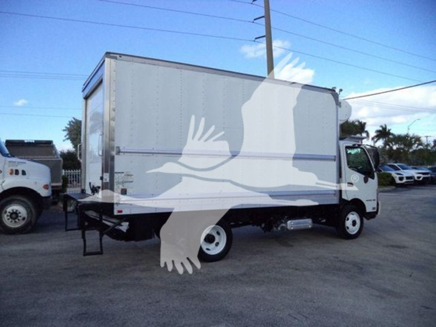 Hino 195 refrigerated truck side view showing cab, box, and white wheels with no visible branding text.