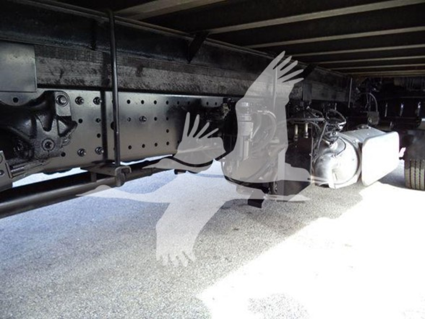 Chassis underside of a 2020 Hino 195 refrigerated truck showing frame rails, axle components, and underbelly hardware.