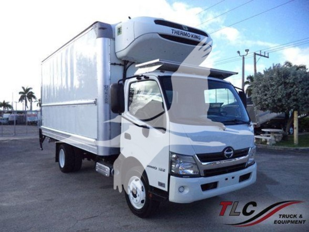 Hino 195 refrigerated box truck with Thermo King reefer unit on top; front grille and cab visible; white truck in a lot.
