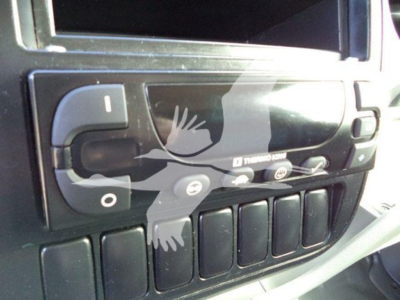 Truck cab interior showing glove box controls and dashboard switches in a 2020 Hino 195 refrigerated truck.
