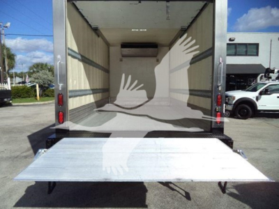 Truck cargo area of a 2020 Hino 195 with rear liftgate extended open, refrigerated box interior visible.
