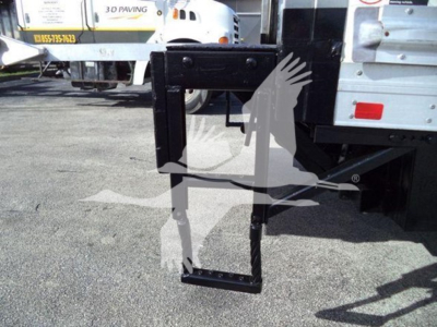 Truck hitch or lift mechanism attachment visible under a refrigerated 2020 Hino 195 yard with black steel frame and white body in background.