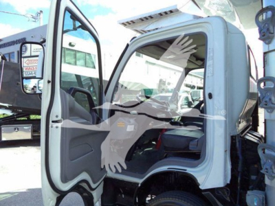 Cab doorway of a 2020 Hino 195 refrigerated truck showing interior and front door open