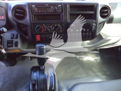 Dashboard of a refrigerated 2020 Hino truck showing center console with climate controls, radio, and gear shifter in view.