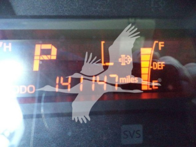 Vehicle dashboard showing odometer reading 141,147 miles and fuel gauge; transmission in Park; DEF and fuel indicators visible on right.