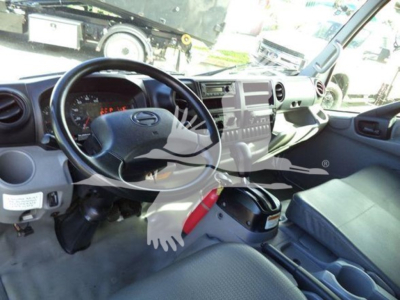 Cab interior of a 2020 Hino 195 refrigerated truck showing steering wheel, dashboard, center console, and seating.