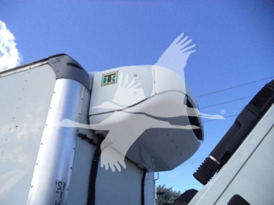 Truck refrigeration unit on a 2020 Hino 195 commercial truck, side view of cab roof with cooling unit housing and blue sky.
