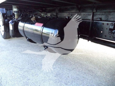 Underbody view of a refrigerated truck showing a cylindrical fuel/delivery tank with mounting straps and undercarriage components.