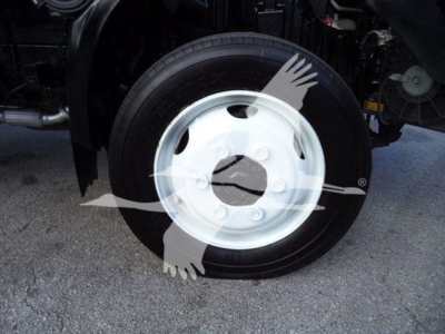Wheel and front axle of a 2020 Hino 195 refrigerated truck showing a white steel wheel and black tire.