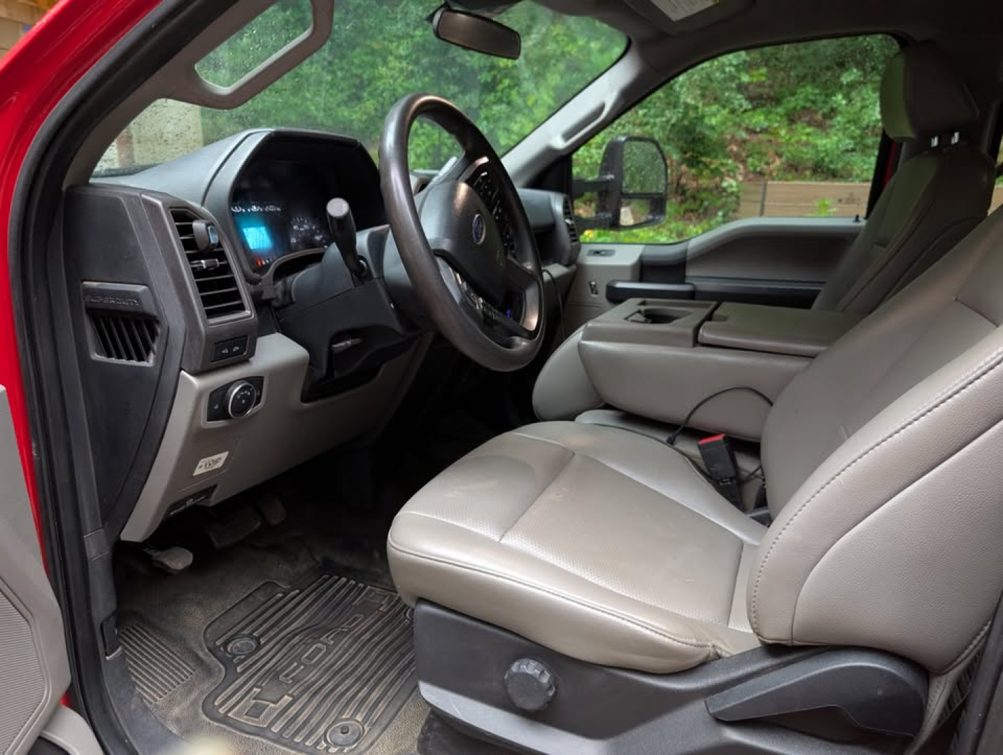 Ford F-450 Super Duty XL interior showing front seats steering wheel and dashboard.