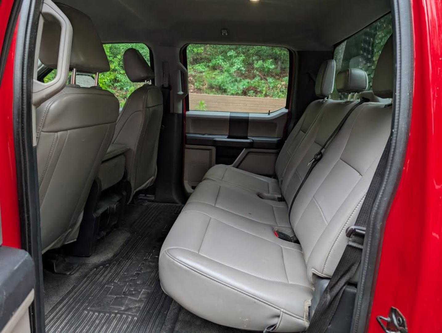 Ford F-450 Super Duty XL Crew Cab interior with light gray leather seats in second row and rear seating visible