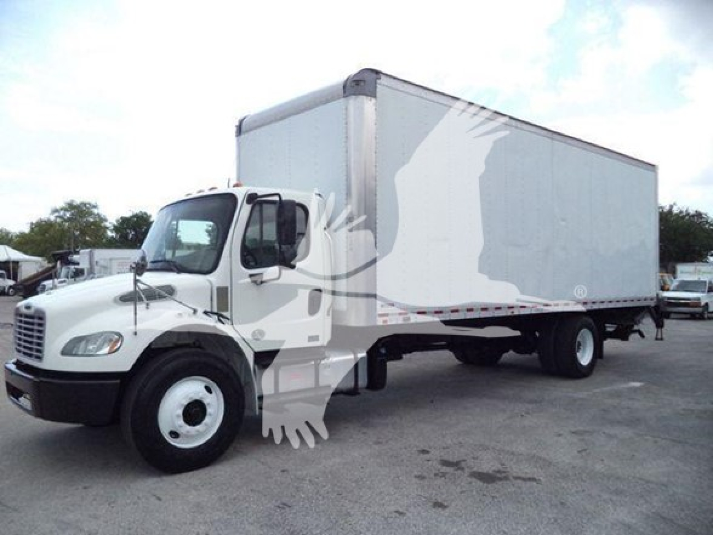 Freightliner M2 106 box truck side view showing cab and long box cargo area with white exterior.