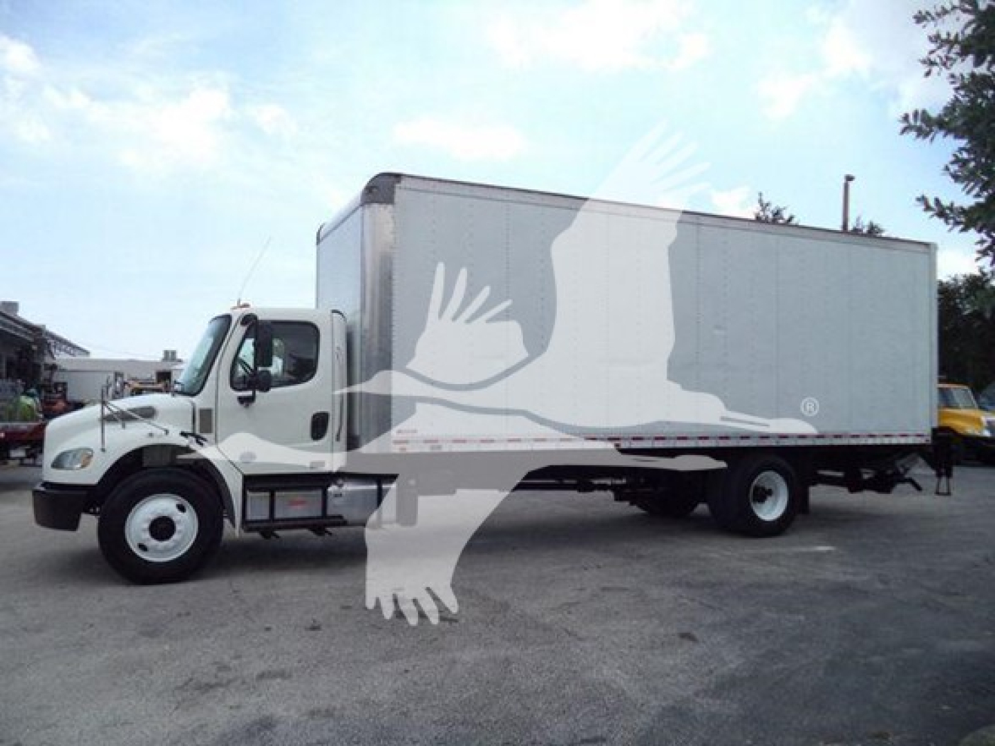 Freightliner M2 106 box truck in profile showing cab and large box with no visible text.