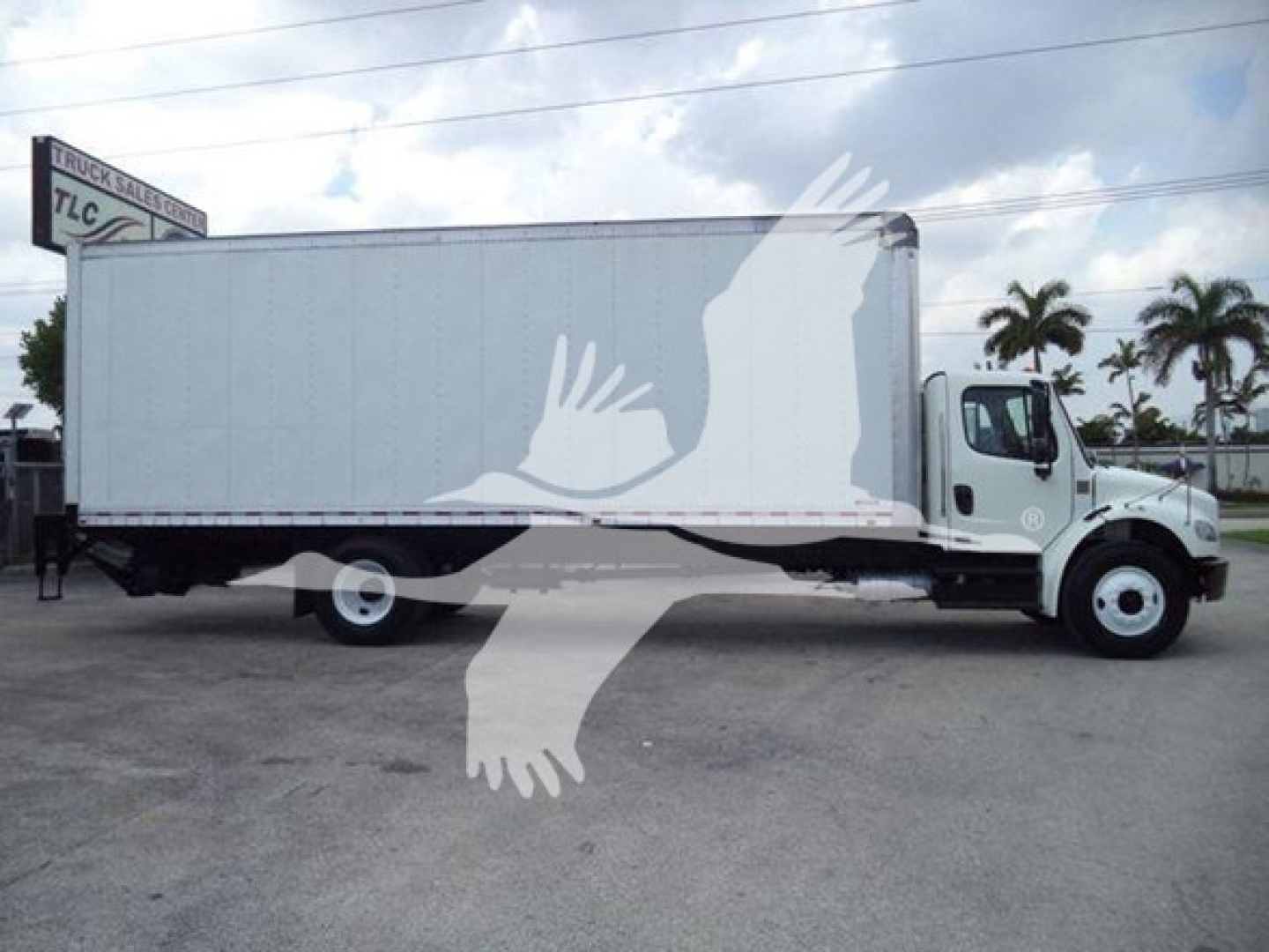 Freightliner M2 106 box truck side view with white cargo body and chassis.