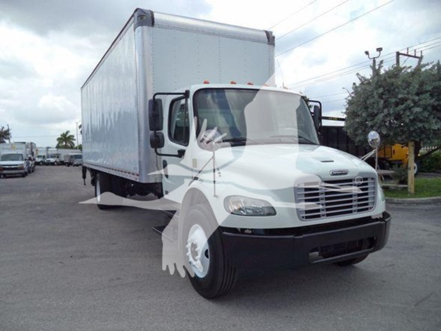 Box truck from front-left view showing Freightliner M2 106 cab and box with faded logo watermark overlay