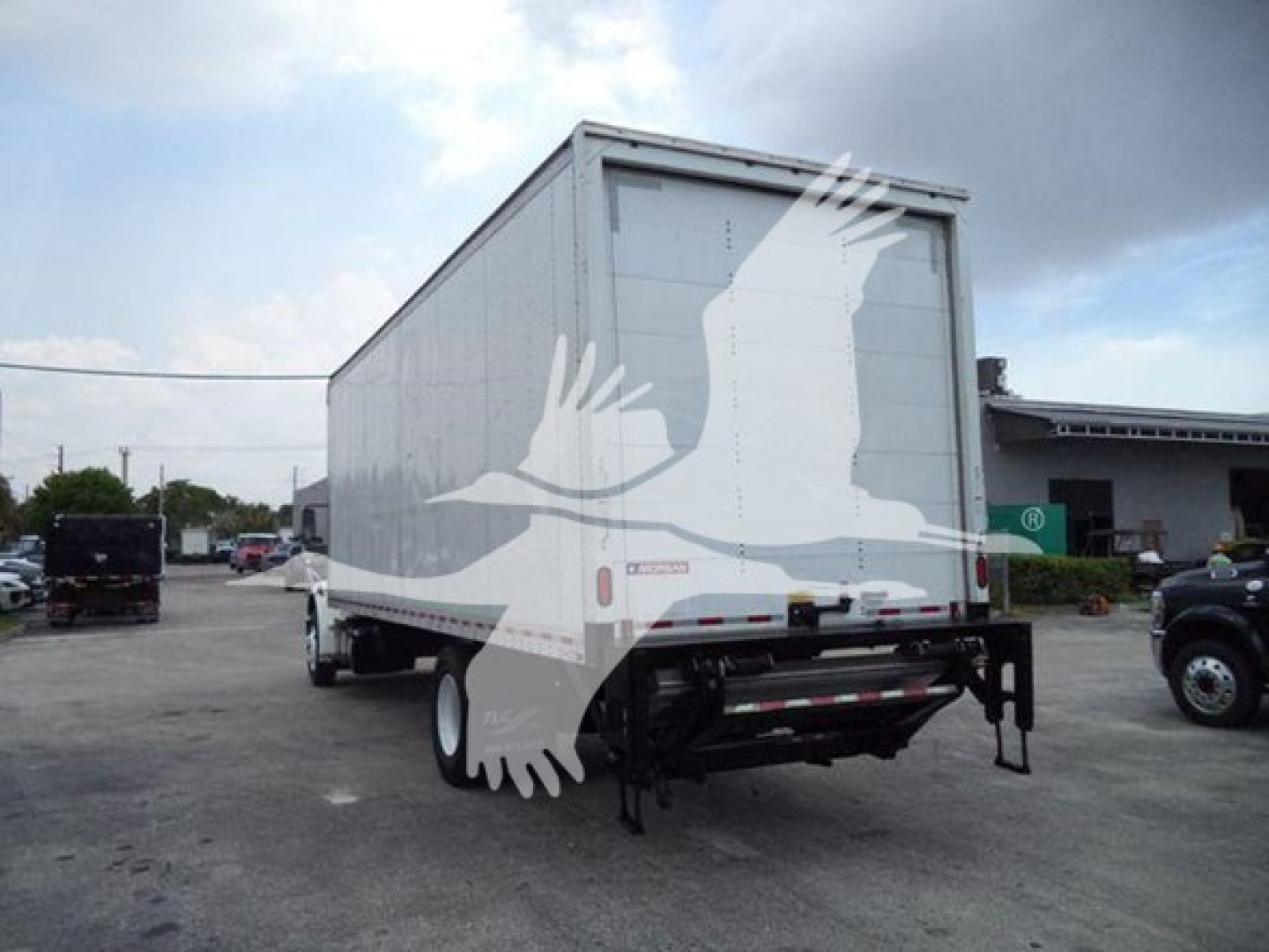 Freightliner M2 106 box truck rear view showing cargo box and undercarriage details.