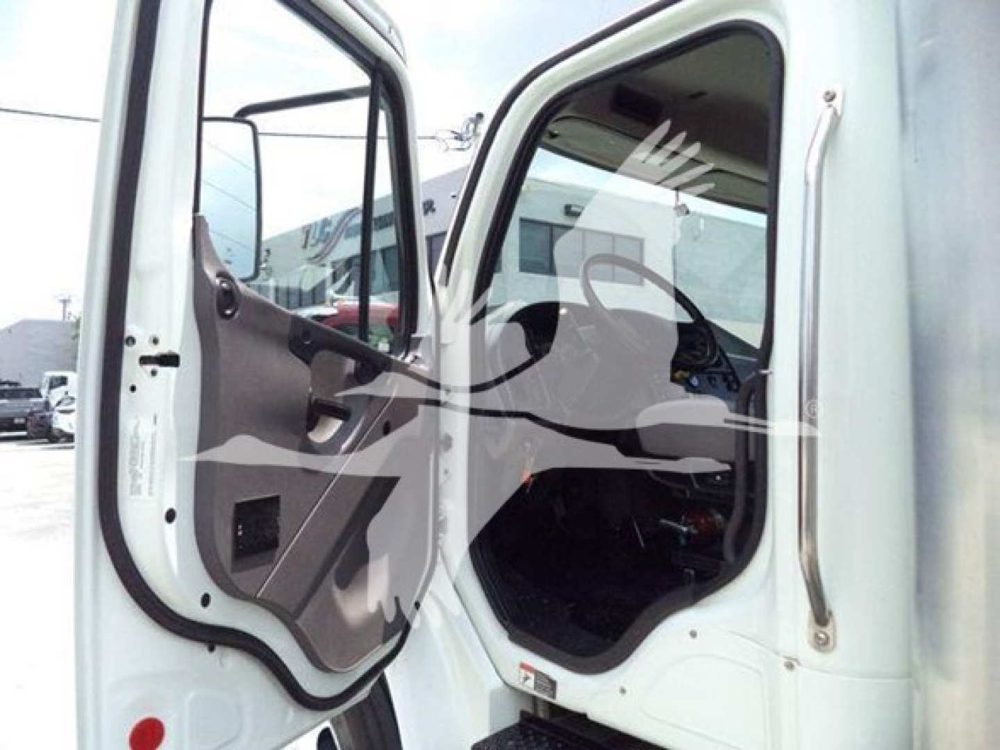 Truck cab door area of a 2020 Freightliner M2 106 showing interior entry and door with weatherstripping.