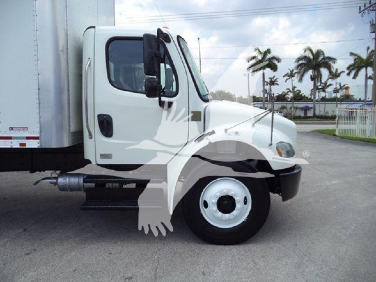 Freightliner M2 106 truck cab side view with box trailer, showing front wheel, door, and side mirror.