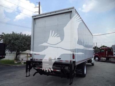 Box truck rear view showing Freightliner M2 106 cargo area with white box and graphic of birds; hydraulic lift gates and rear bumper visible.