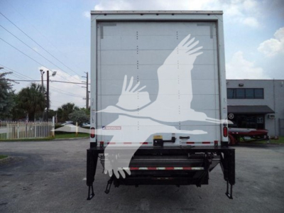 Freightliner M2 106 box truck rear view showing overhead doors, taillights, and hydraulic lift; no legible labels visible on the back of the box.