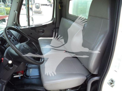 Truck cab interior of a 2020 Freightliner M2 106 showing driver seat and passenger seat with steering wheel and dashboard visible.