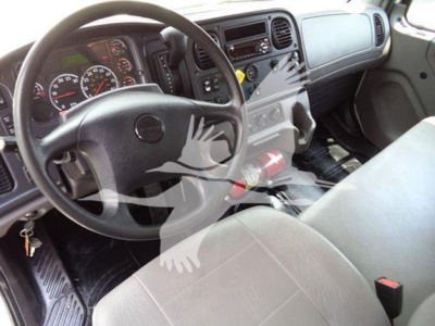 Freightliner M2 106 cab interior showing steering wheel, dashboard gauges, center console, and driver seat.