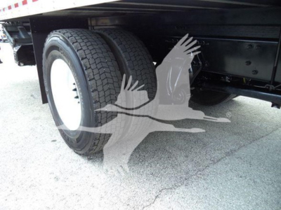 Freightliner M2 106 rear wheel well and dual-tire axle underbox showing suspension and frame.