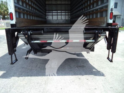 Freightliner M2 106 rear view showing undercarriage and tail area with liftgate supports and hydraulic lines.