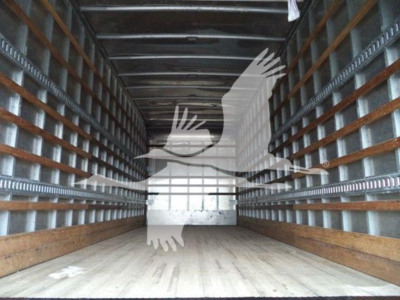 Freightliner M2 106 truck cargo area showing empty box bed with wooden floor and metal side rails.