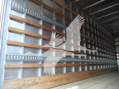 Freightliner M2 106 truck interior/box trailer wall with side rails and wooden floor, silhouette logo overlay.