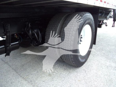 Freightliner M2 106 undercarriage with dual rear tires and suspension components visible.