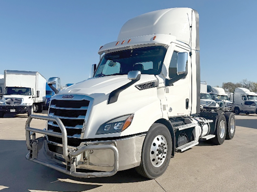 Freightliner Cascadia semi-truck tractor in white, front grille guard, chrome bumper, daytime; no visible text legible on parts.