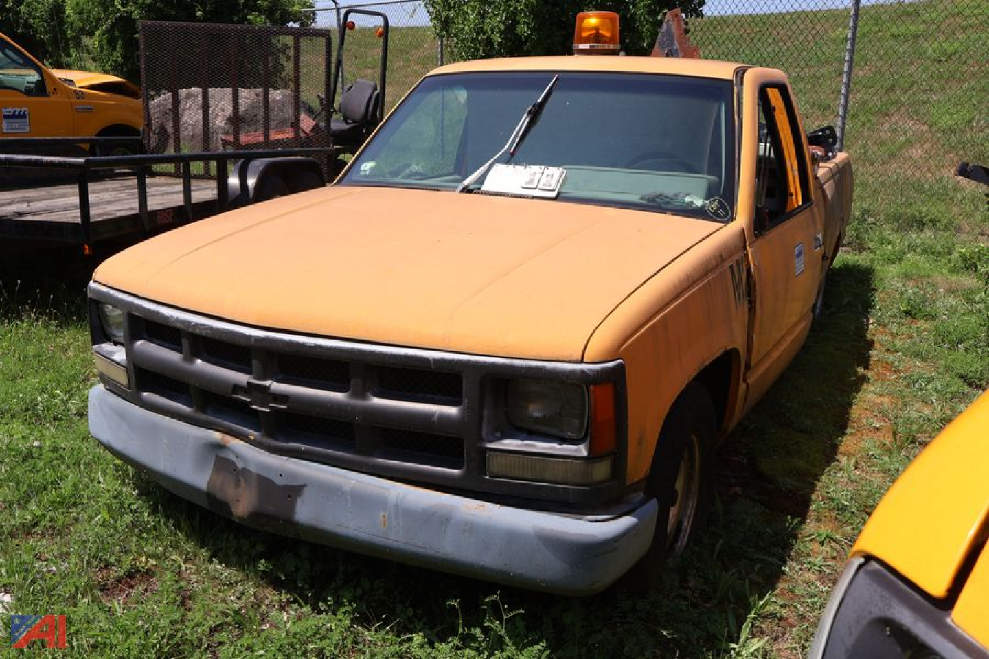 1993 Chevrolet C/K 1500 pickup truck front-left view with orange faded paint and weathered bumper.