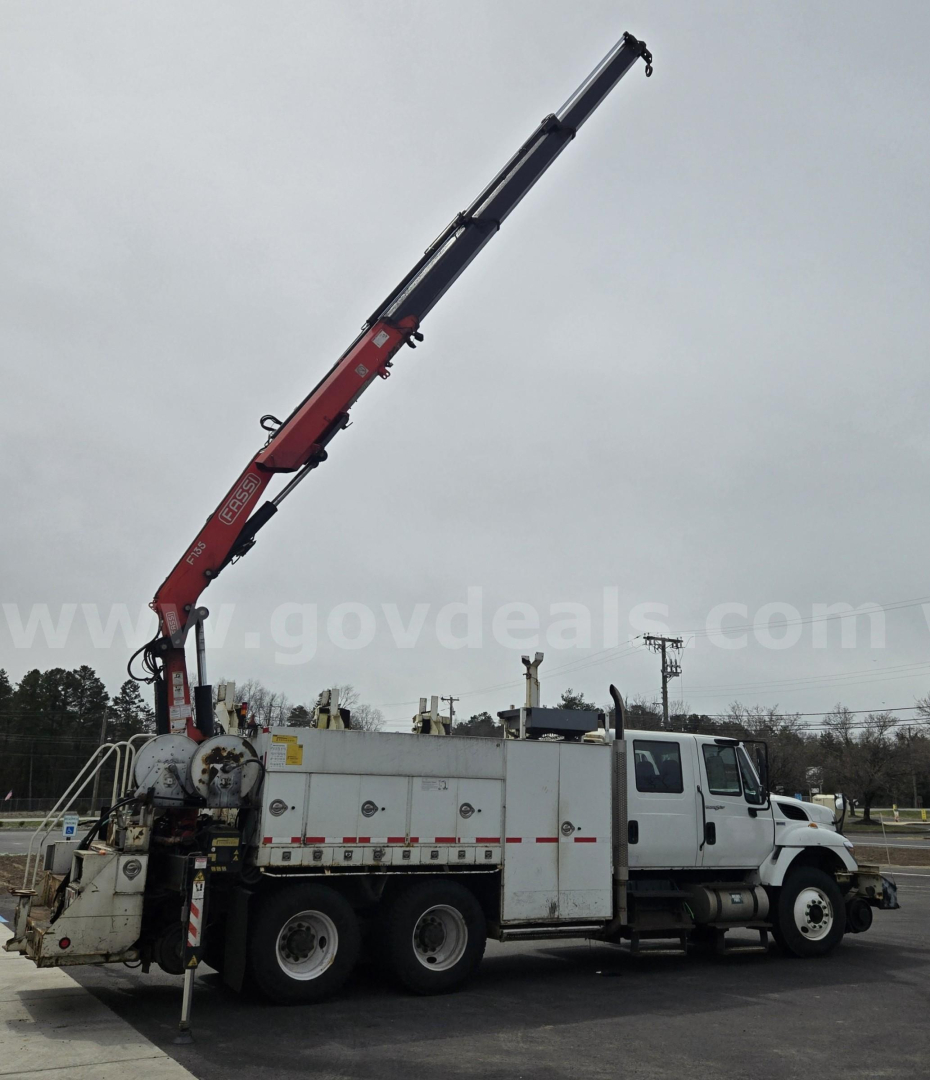 Truck-mounted crane on a white service truck aiming upward with boom extended.