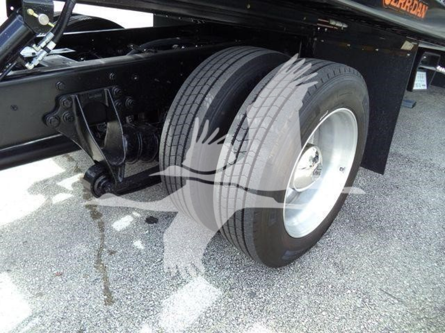 Truck chassis near dual rear wheels showing suspension and tire details on a 2019 International 4300 rollback.