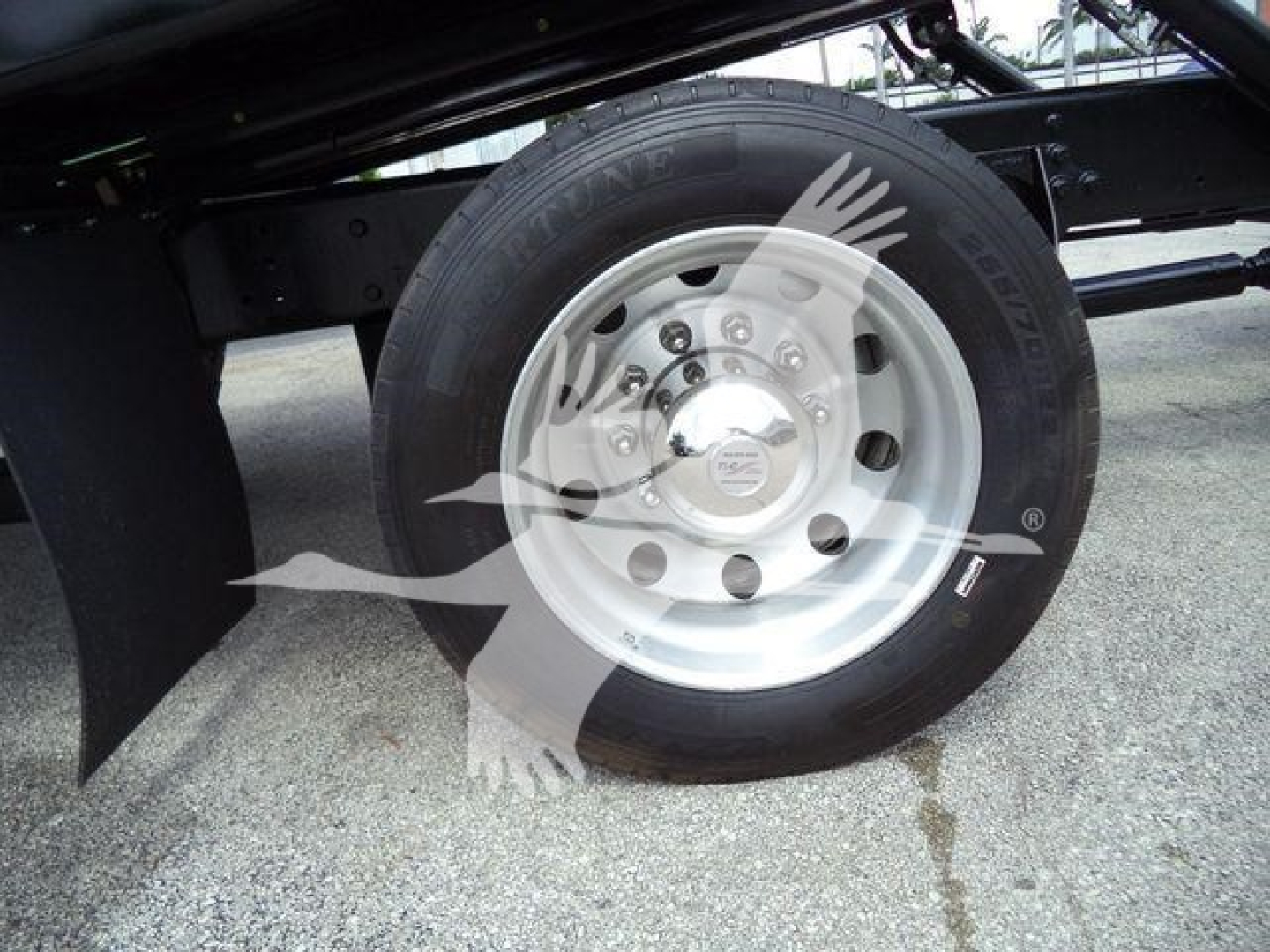 Wheel and tire on a 2019 International 4300 rollback truck showing front steel rim and Hankook tire with hubcap and surrounding chassis.