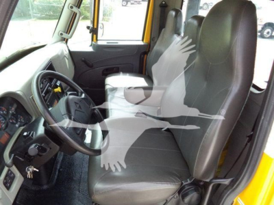 Cab interior of a 2019 International 4300 rollback truck showing steering wheel, driver and passenger seats, dashboard, and door panels.
