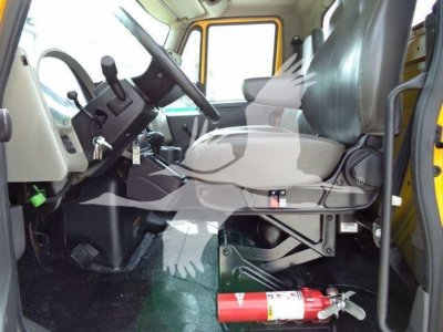 Truck cab interior of a 2019 International 4300 rollback showing steering wheel, driver seat, and dashboard